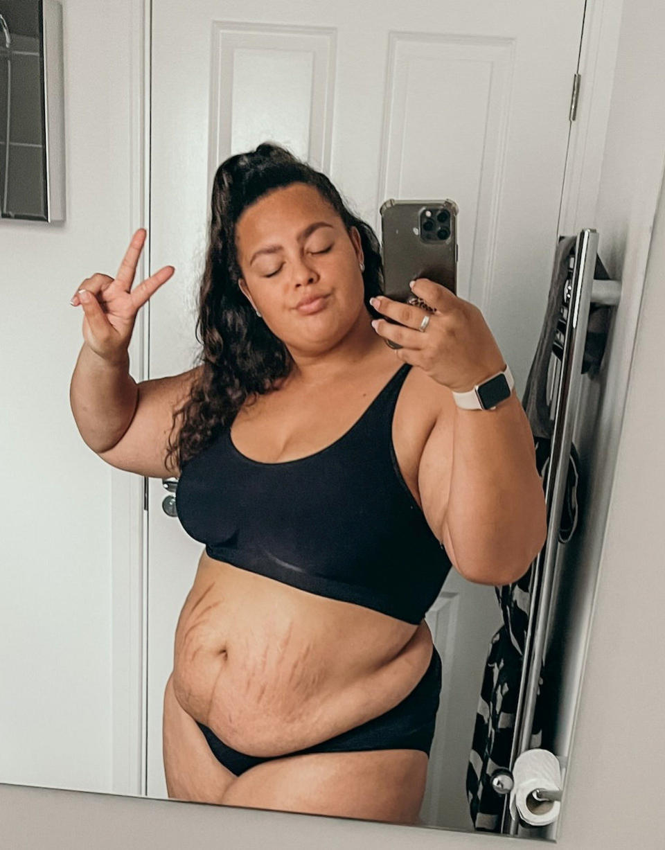 Jaz Harris posing in the mirror, to help other women find body confidence. (SWNS)