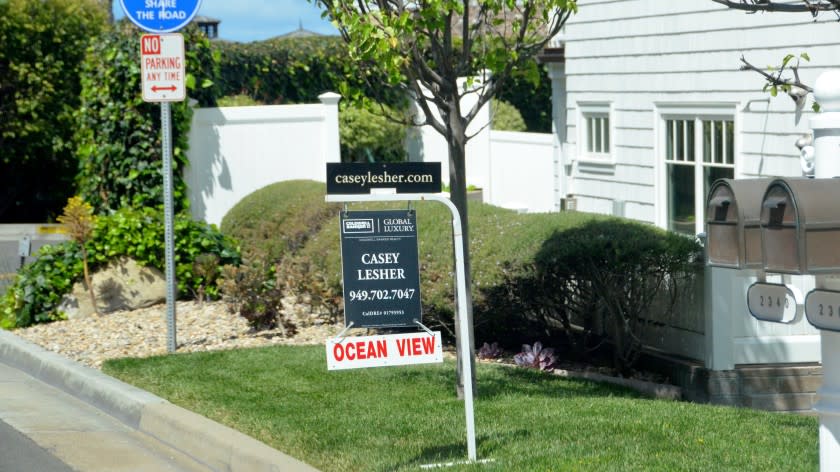 "Ocean View" attached to the home's for sale sign grabs drivers' attention as they make their way along Bayside Drive in Corona del Mar, on April 26, 2021.