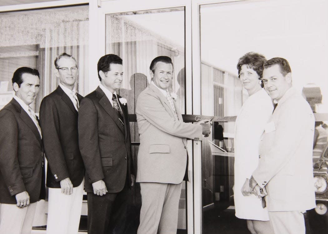 Cecil Clark and employees open doors in 1972.