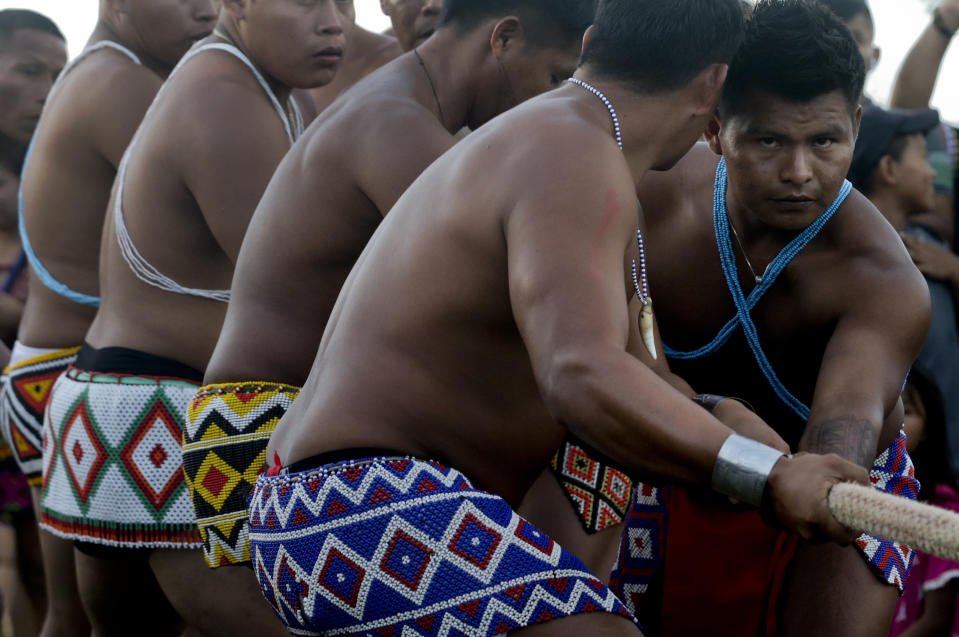 In this Nov. 25, 2018 photo, Embera indigenous men participate in the tug-of-war competition during the second edition of the Panamanian indigenous games in Piriati, Panama. The Embera won the tug-of-war competition. (AP Photo/Arnulfo Franco)