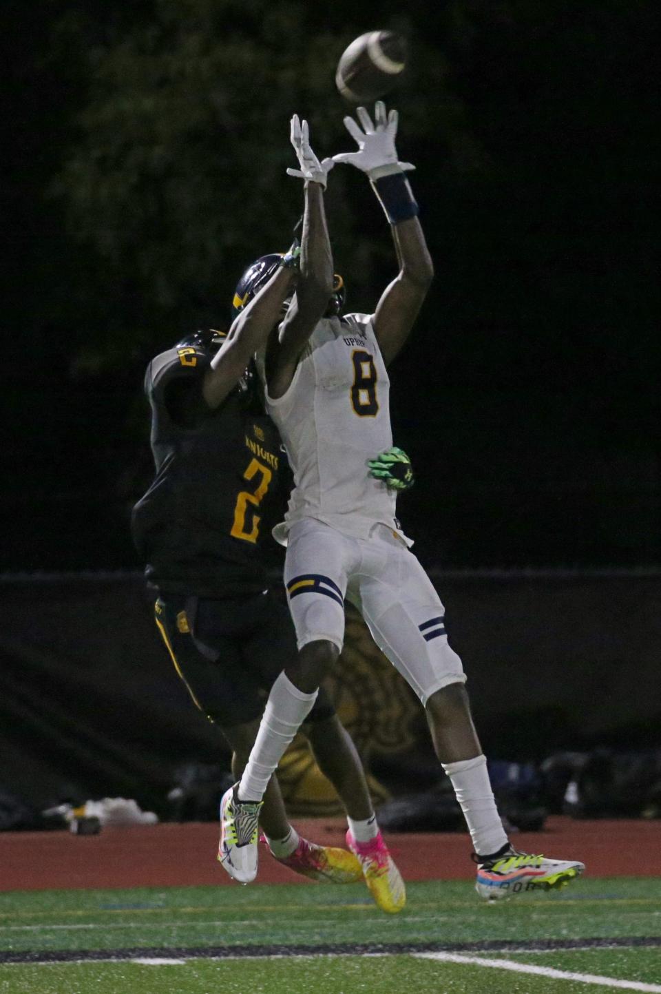 UPrep wide receiver Tyrell Simmons (8), pulls in a deep ball along the sidelines over McQuaid's Gabe Zawallow (2), in the first half during their Section V matchup Friday night, Sept. 9, 2022 at McQuaid.