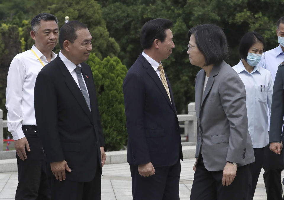 Taiwan's President Tsai Ing-wen, front right, greets Taiwan's Nationalist Party presidential candidate Hou Yu-ih, second left, during a ceremony commemorating the 65th anniversary of deadly attack by China on Kinmen island, in Kinmen, Taiwan, Wednesday, Aug. 23, 2023. (AP Photo/Chiang Ying-ying)