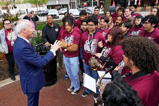 PHOTO: Former Arkansas Gov. Asa Hutchinson talks with members of the Springdale High School band before formally announces his Republican campaign for president, April 26, 2023, in Bentonville, Ark. (Sue Ogrocki/AP)