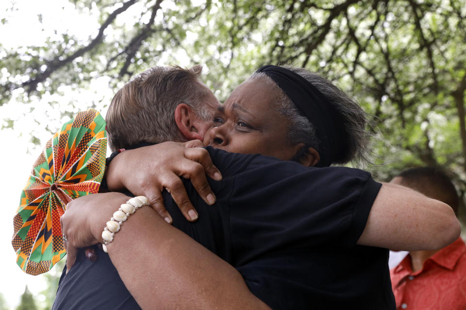 Father Michael Pfleger and Jan Hood, 63, embrace each other following his reinstatement by Archdiocese of Chicago, Monday, May 24, 2021, in front of St. Sabina Catholic Church in the Auburn Gresham neighborhood in Chicago. (AP Photo/Shafkat Anowar)