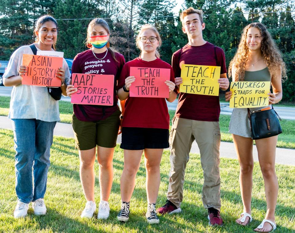 From left: Rabia Ahmed, a 2020 Muskego High School graduate; Raimi Liebel, a Muskego High graduate; Maya Liebel, a 2022 Muskego High graduate; Jarret Dietzler, a junior at Muskego High; and Mollie Kinter, 2020 Muskego High graduate, hold signs in support of the Community Teach-in outside of the Educational Services Center Building in Muskego.