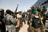 <p>Shiite fighters with Iraqi security forces gather near Fallujah, Iraq, on May 24, 2016. (Thaier Al-Sudani/Reuters) </p>