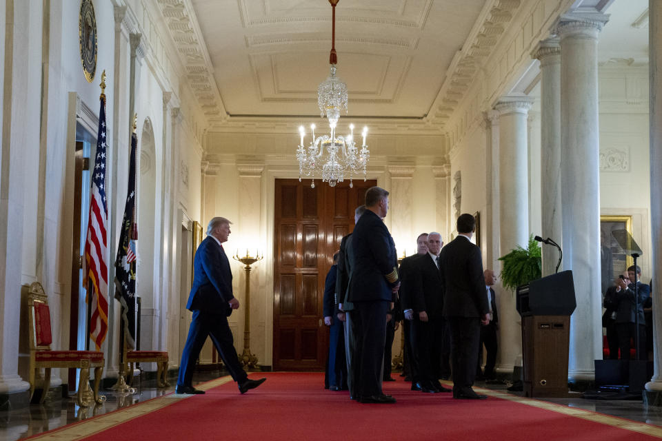 President Donald Trump, left, arrives to address the nation on the ballistic missile strike that Iran launched against Iraqi air bases housing U.S. troops, at the White House, Wednesday, Jan. 8, 2020, in Washington. (AP Photo/Alex Brandon)