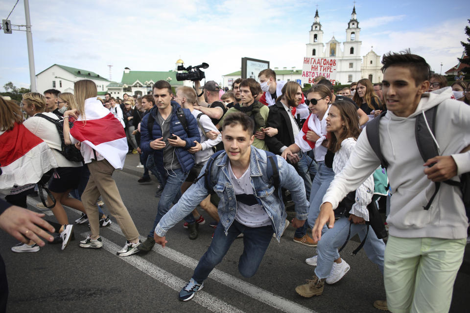 Students run away from police during a protest in Minsk, Belarus, Tuesday, Sept. 1, 2020. Several hundred students on Tuesday gathered in Minsk and marched through the city center, demanding the resignation of the country's authoritarian leader after an election the opposition denounced as rigged. Many have been detained as police moved to break up the crowds. (Tut.By via AP)