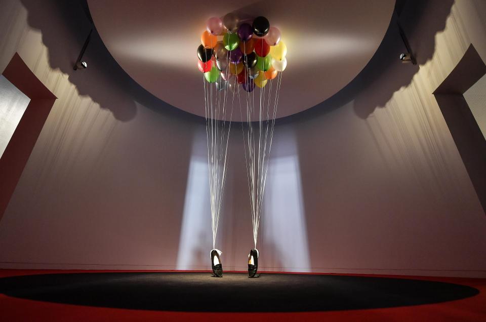 A sculpture, comprised of balloons lifting a pair of penny loafer shoes by British artist Appau Junior Boakye-Yiadom is shown at a preview of the exhibition 'Michael Jackson: On The Wall' at the Bundeskunsthalle museum in Bonn, Germany, Thursday, March 21, 2019. The exhibition around the controversial iconic pop idol is open until July 14. (AP Photo/Martin Meissner)