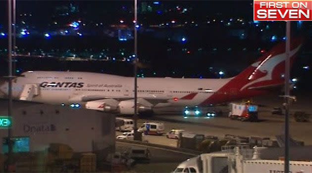 Paramedics board Qantas flight QF28 at Sydney Airport. Photo: 7News