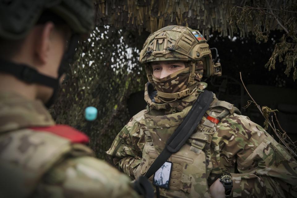 In this photo taken on Friday, April 26, 2024 and released by the Russian Defense Ministry Press Service, Russian soldiers talk to each other near their position in an undisclosed location in Ukraine. (Russian Defense Ministry Press Service via AP)