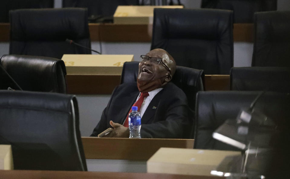 Former South African President Jacob Zuma, laughs as he waits for the state capture hearings to get underway in Johannesburg, Tuesday, Nov. 17, 2020. Zuma is appearing before a state commission investigating serious allegations of corruption during his tenure as head of state between 2009 and 2018. (AP Photo/Themba Hadebe)