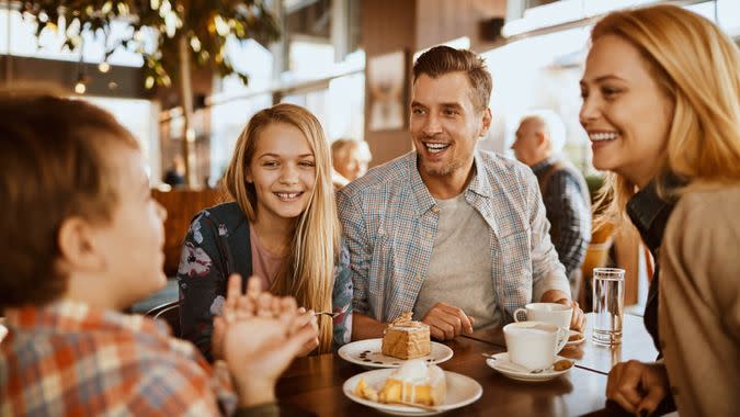 Close up of a young family spending time in a cafe.