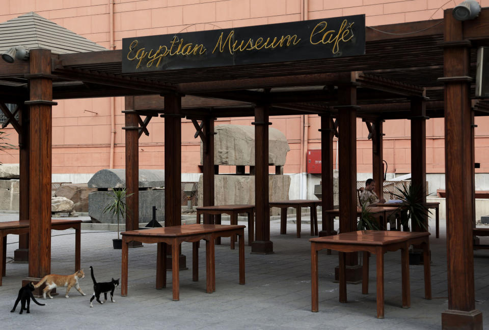 In this Wednesday, Oct. 30, 2013 photo, an Egyptian military solider reads at a cafe in front the empty gift shop in the Egyptian Museum near Tahrir Square in Cairo, Egypt. The 111-year-old museum, a treasure trove of pharaonic antiquities, has long been one of the centerpieces of tourism to Egypt. But the constant instability since the 2011 uprising that toppled autocrat Hosni Mubarak has dried up tourism to the country, slashing a key source of revenue. Moreover, political backbiting and attempts to stop corruption have had a knock-on effect of bringing a de facto ban on sending antiquities on tours to museums abroad, cutting off what was once a major source of funding for the museum.(AP Photo/Nariman El-Mofty)