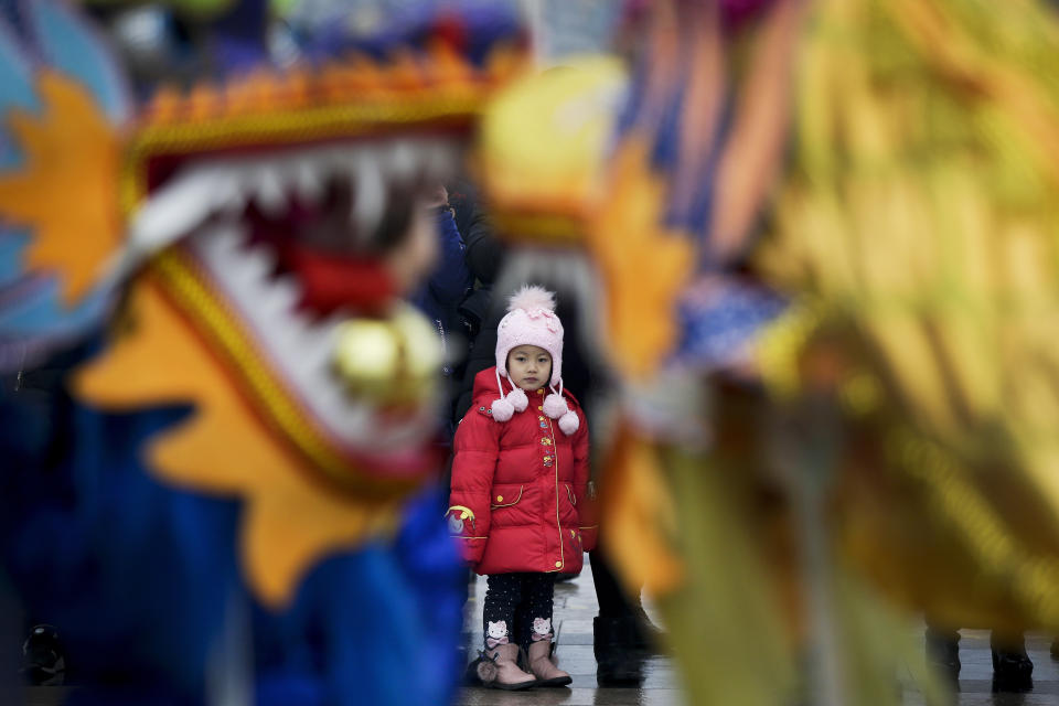 In this Tuesday, Feb. 19, 2019, file photo, a child watches dragon dance performance during the Lantern Festival organized by city government at a square in Yufa town of Beijing's Daxing district. Tuesday marks the Lantern Festival in China, the final day of the annual celebration of the Chinese Lunar New Year. (AP Photo/Andy Wong, File)