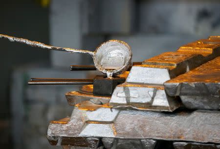 FILE PHOTO: A worker takes a sample of molten alumnium in a shop of Kazakh mining company Eurasian Resources Group's (ERG) Kazakhstan Aluminium Smelter JSC (KAS) factory in Pavlodar, Kazakhstan February 20, 2018. REUTERS/Shamil Zhumatov/File Photo