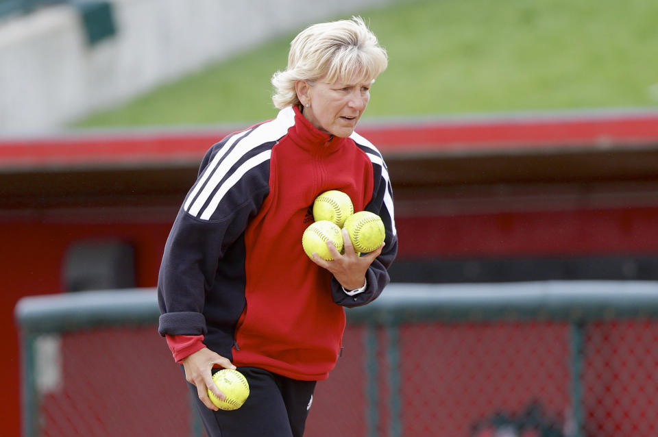 Nebraska coach Rhonda Revelle collects softballs during practice in Lincoln, Neb., Wednesday, May 22, 2013. Nebraska plays Oregon in a best-of-three NCAA college softball Super Regional series starting Saturday night in Eugene, Ore.  (AP Photo/Nati Harnik)