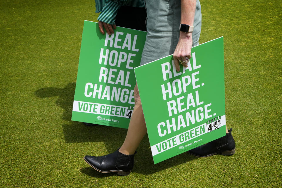 Green Party supporters carry placards at their General Election Manifesto launch - Real Hope, Real Change, at Sussex County Cricket Ground in Hove, East Sussex, England, Wednesday, June 12, 2024. In the build-up to the UK general election on July 4. (AP Photo/Kirsty Wigglesworth)