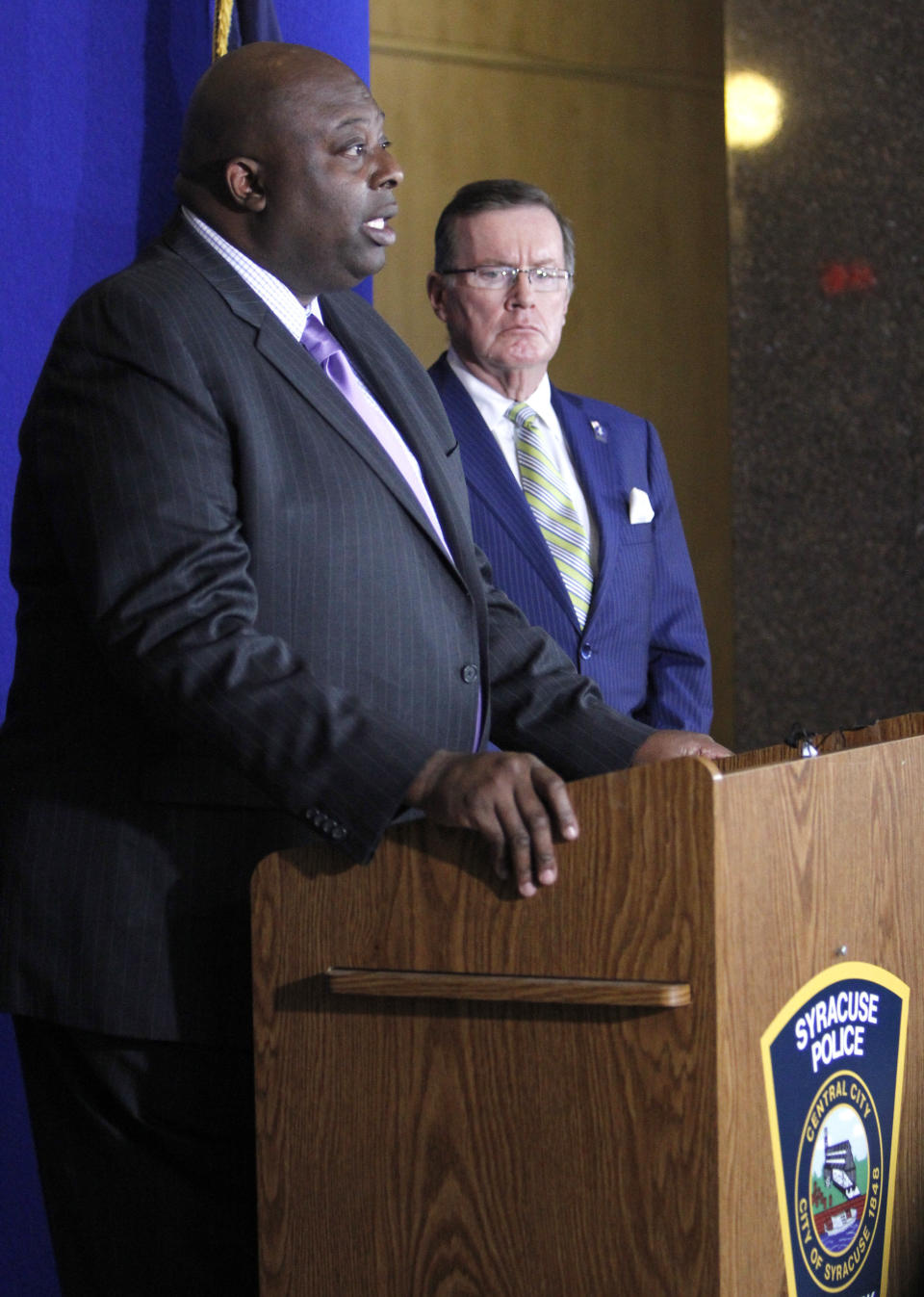 Syracuse Police Chief Kenton T. Buckner, left, and Onondaga County District Attorney William J. Fitzpatrick, right, attend a news conference at the Syracuse Police Department in Syracuse, N.Y., Thursday, Feb. 21, 2019, about Syracuse men's NCAA college basketball head coach Jim Boeheim's involvement in a fatal car accident where he struck and killed a man standing along an interstate in Syracuse. Boeheim struck and killed a man along an interstate late Wednesday night as he tried to avoid hitting the man's disabled vehicle, police say. (AP Photo/Nick Lisi)