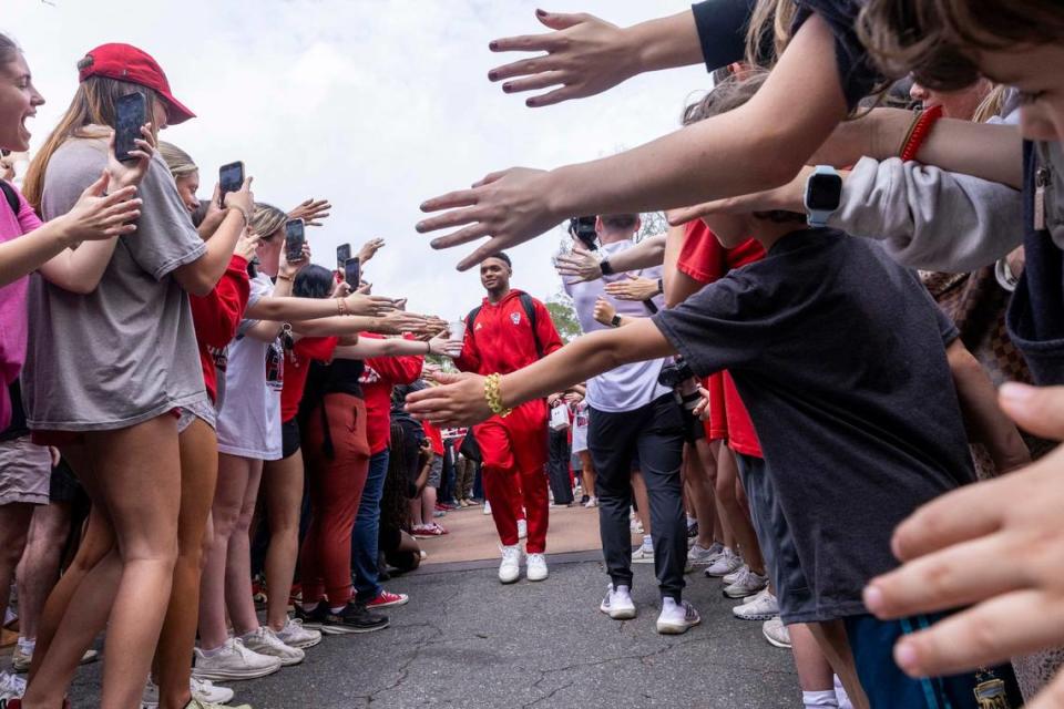 NC.State’s Casey Morsell is greeted by fans as the men’s basketball team departs on a bus Wednesday, April 3, 2024. NC State’s men’s basketball team is headed to the Final Four for the first time since 1983. Travis Long/tlong@newsobserver.com