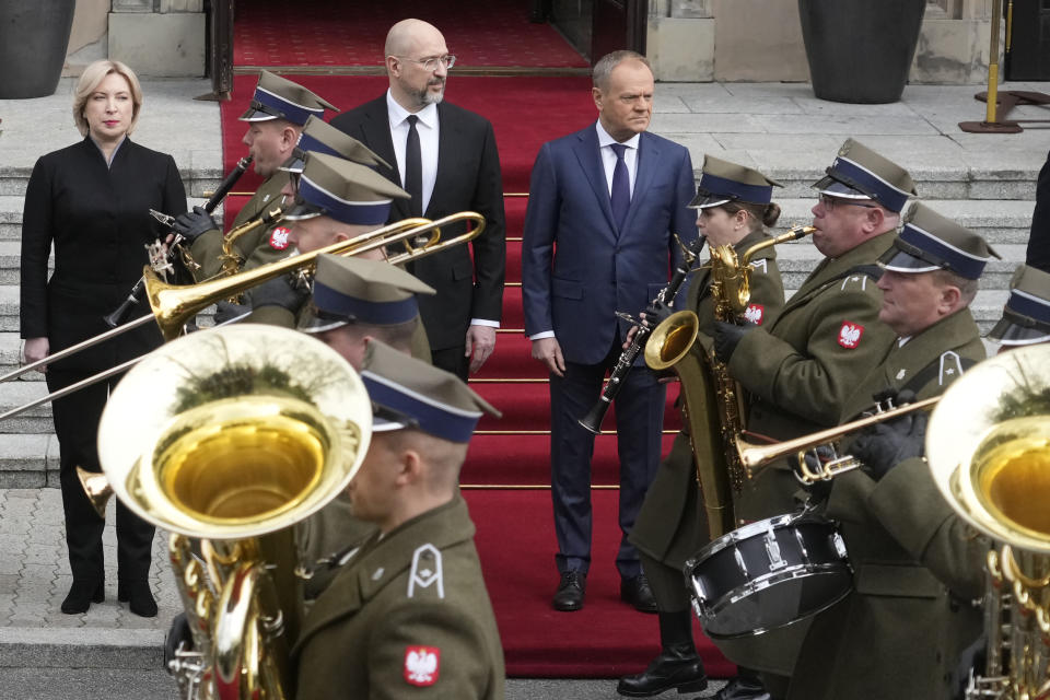 Ukrainian Prime Minister Denys Shmyhal, second left, and his Polish courtnerpart, Prime Minister Donald Tusk, right, review troops during a welcoming ceremony ahead of their talks in Warsaw, Poland, Thursday March 28, 2024. (AP Photo/Czarek Sokolowski)
