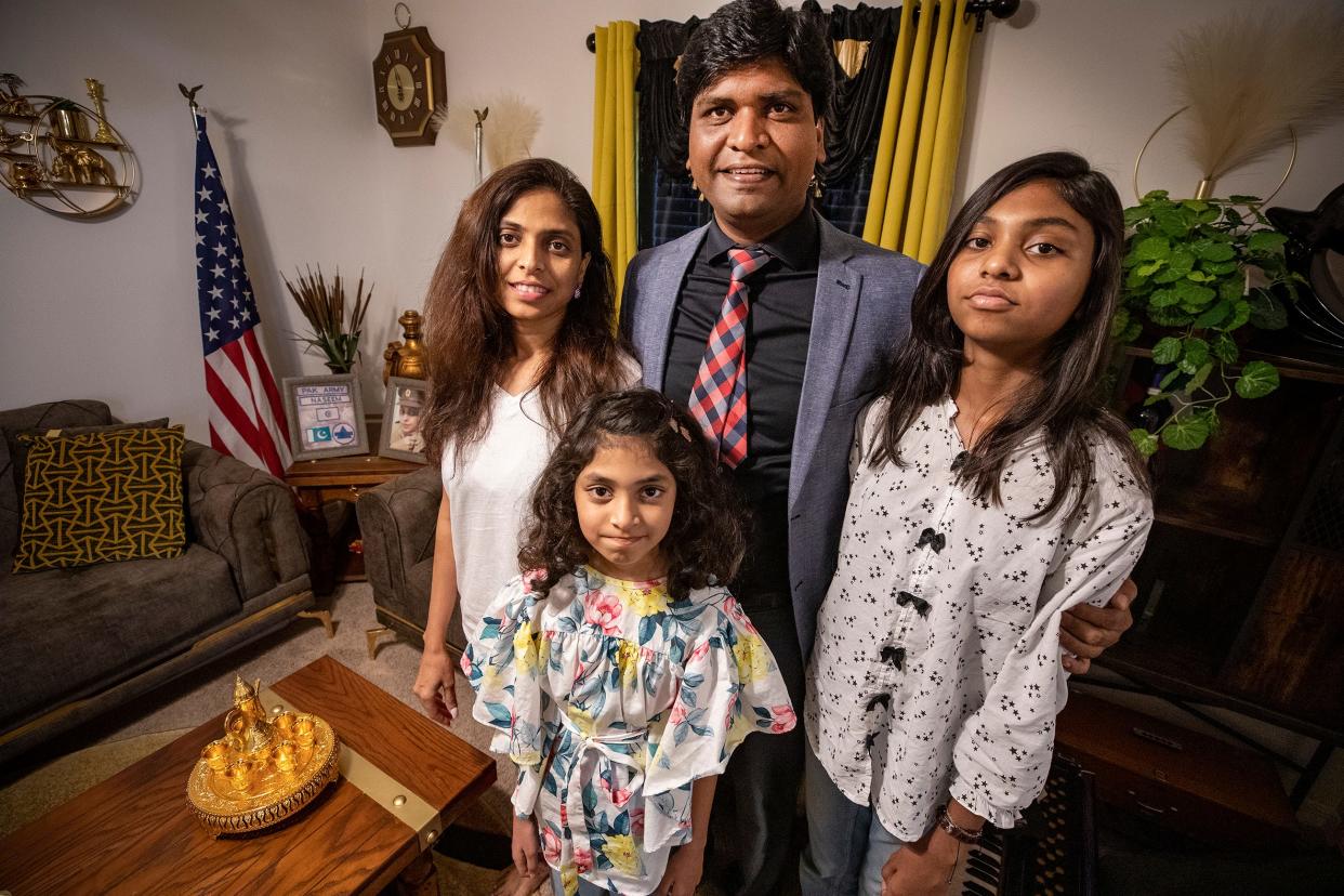 Junaid Saqib and his wife, Naseem Naz, stand with their daughters, Mishmal Junaid, 9, and Imsaal "Cherry" Junaid, 11, at their home in Lakeland. Junaid Saqib came to Lakeland in 2017, fleeing his native Pakistan, where he faced threats as a Christian in a Muslim country. His wife and daughters finally joined him here in May.