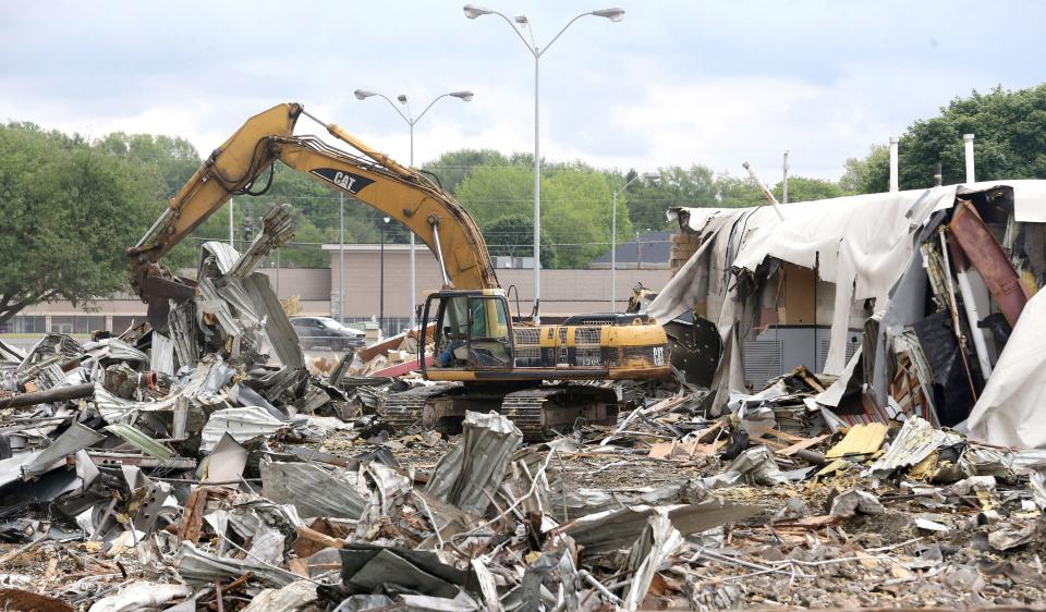 The former Kmart building in North Canton is torn down on Tuesday.