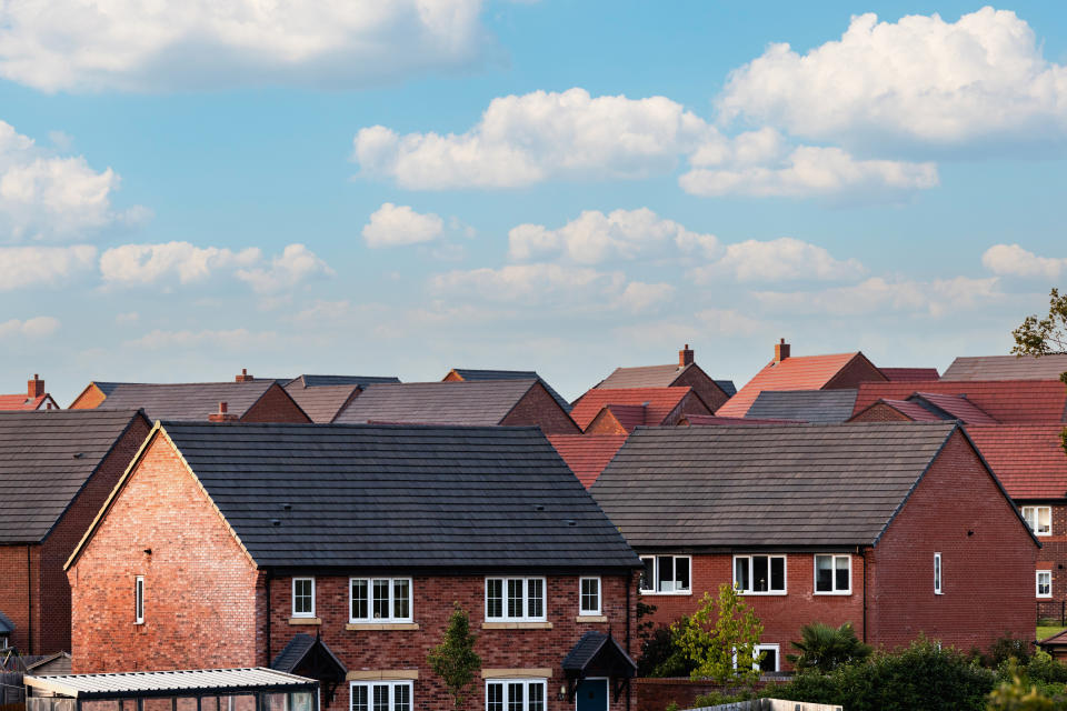 shared ownership Houses in England with typical red bricks on a sunny day - View of a new estate with typical British houses under a blue sky - Real estate and buildings concepts in UK