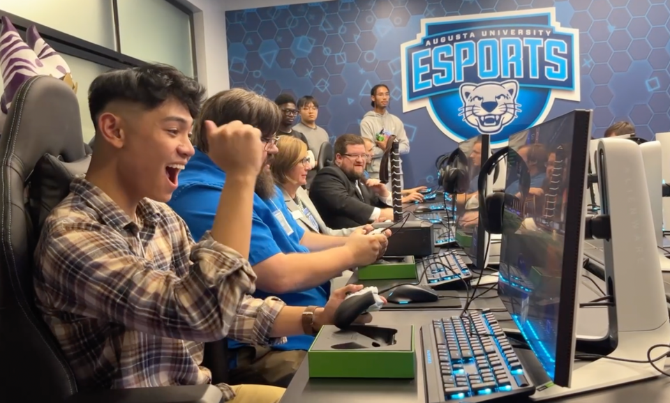 Augusta University Esports Founder and Rocket League Coach Jordan Moratin, left, enjoys a victory while playing Rocket League in AU's newly unveiled arena at the Georgia Cyber Center on Monday, Oct. 23, 2023.