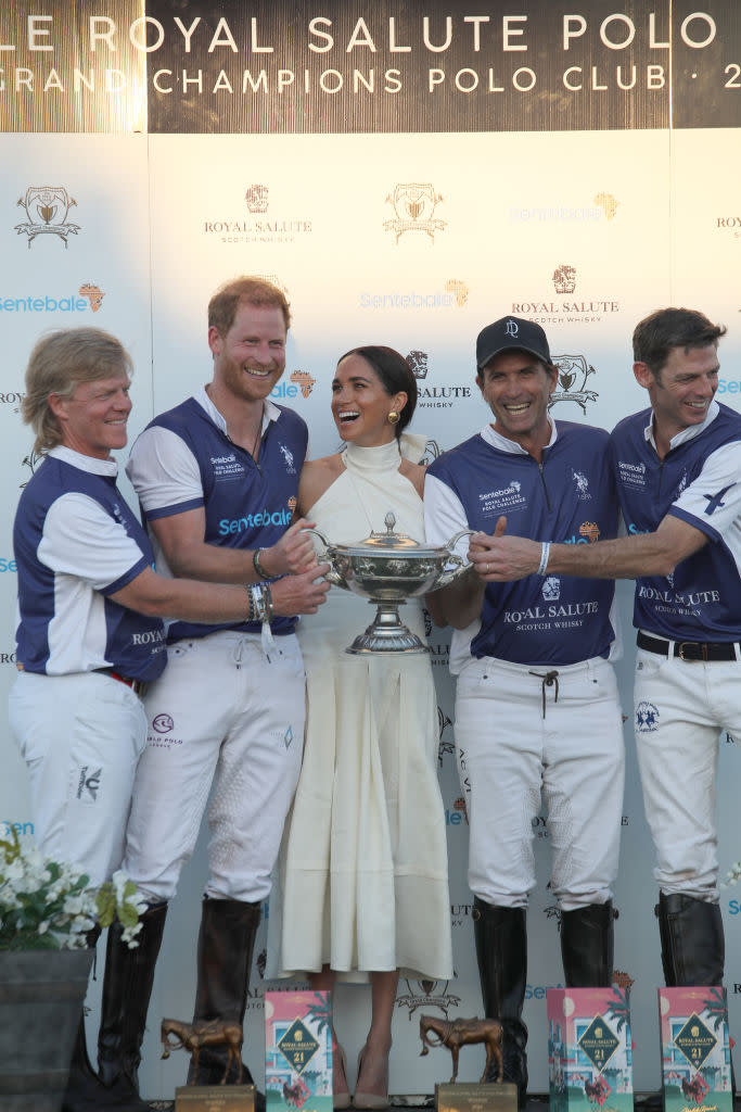 favorite fashion clothing brands meghan markle wears, Meghan Markle presents a trophy to Prince Harry at the Royal Salute Polo Challenge on April 12, Heidi Merrick, white halter dress, California
