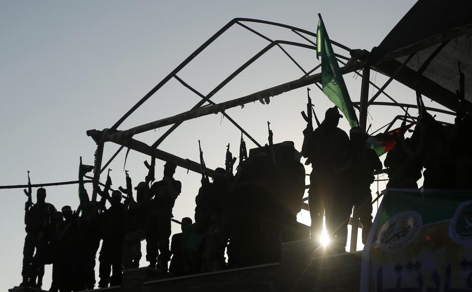 Hamas militants celebrate with people what they said was a victory over Israel in Gaza City