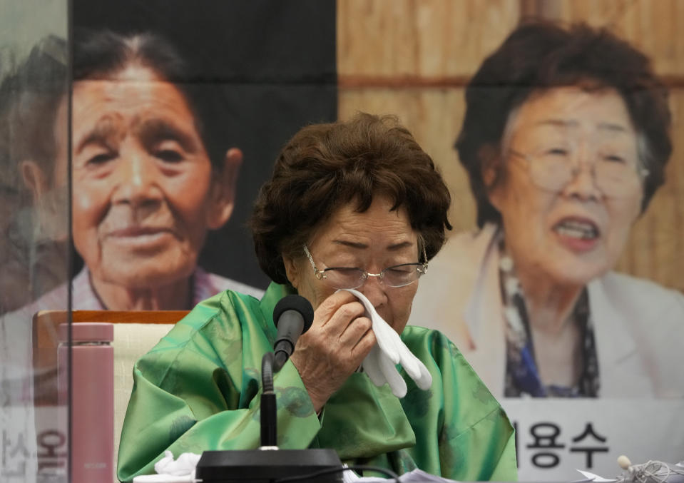 Lee Yong-soo, a South Korean woman who was sexually enslaved by Japan's World War II military, wipes her tears during a news conference at the Korea Press Center in Seoul, South Korea, March 17, 2022. Lee is trying to persuade the governments of South Korea and Japan to settle their decades-long impasse over sexual slavery by seeking judgement of the United Nations. (AP Photo/Ahn Young-joon)