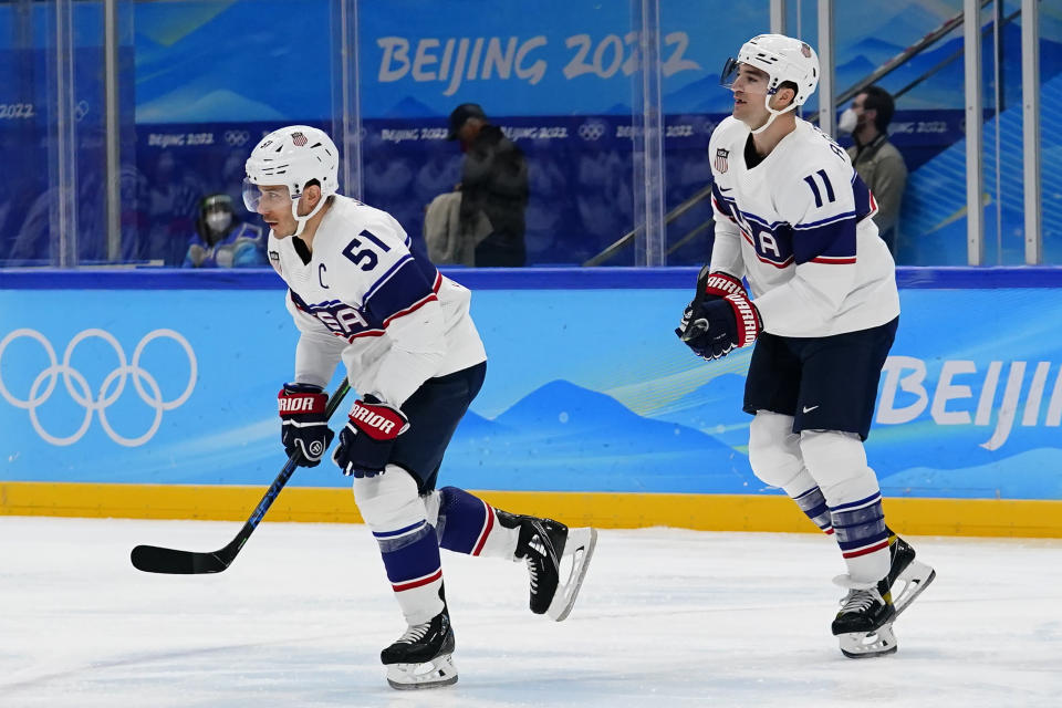 United States' Andy Miele (51) and Kenny Agostino (11) skate to the bench after Miele scored a goal against Canada during a preliminary round men's hockey game at the 2022 Winter Olympics, Saturday, Feb. 12, 2022, in Beijing. (AP Photo/Matt Slocum)