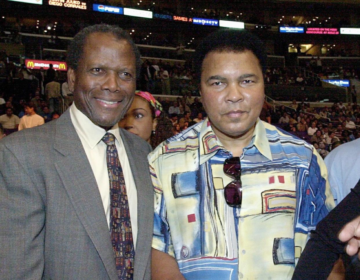 LOS ANGELES, UNITED STATES:  US former boxing heavyweight champion Muhammad Ali (R) meets actor Sidney Poitier (L) as they arrive to watch the WBC welterweight championship between Shane 