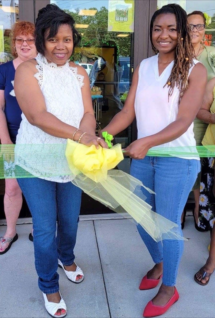 Jessie Elusma, left, and Kemeisha McKenzie celebrate the grand opening of their store, Unique Family Fashion Boutique in Pensacola. Not pictured is the third owner of the owner, Jasmine Rock.