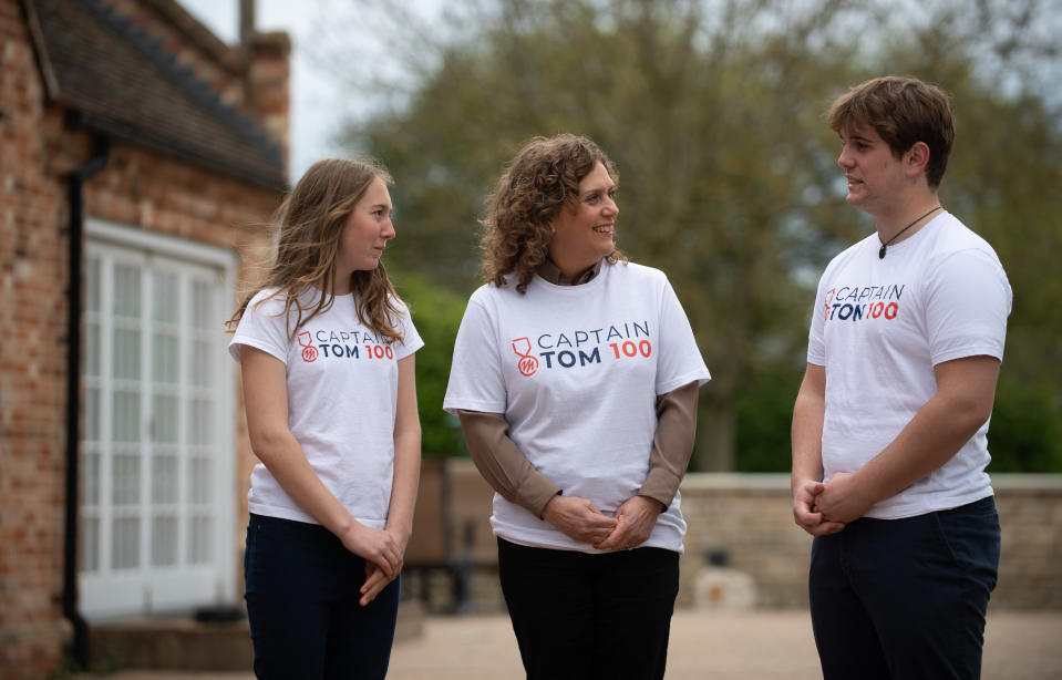 <p>Captain Sir Tom Moore's daughter Hannah Ingram-Moore (centre) and his grandchildren Georgia and Benjie walk laps of their garden in Marston Moretaine, Bedfordshire, as they take part in the "Captain Tom 100" charity challenge. Picture date: Thursday April 29, 2021.</p>
