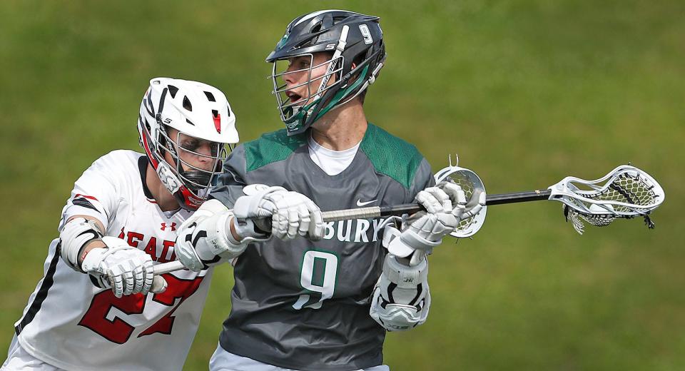 Zachary Falls sets to pass to an open teammate under pressure by Readings Ethan Haggerty.Duxbury suffered a loss to Reading in the in the MIAA Div. 2  lacrosse State Championships at Burlington High on Sunday June 18, 2023 