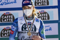 United States' Mikaela Shiffrin shows her bronze medal on the podium of the women's slalom, at the alpine ski World Championships in Cortina d'Ampezzo, Italy, Saturday, Feb. 20, 2021. (AP Photo/Giovanni Auletta)