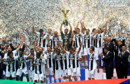 FILE PHOTO: Soccer Football - Serie A - Juventus vs Hellas Verona - Allianz Stadium, Turin, Italy - May 19, 2018 Juventus' Gianluigi Buffon lifts the trophy as the Juventus players celebrate winning the league. REUTERS/Massimo Pinca/File Photo