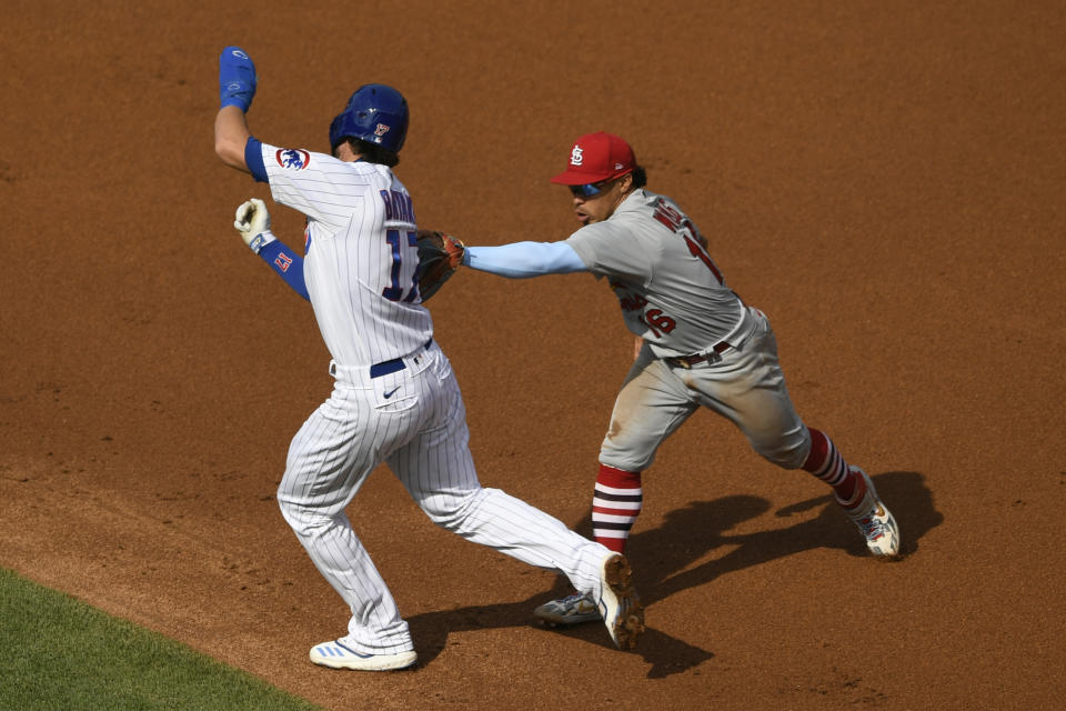 St. Louis Cardinals second baseman Kolten Wong, right, tags out Chicago Cubs' Kris Bryant between first base and second base during the second inning of a baseball game Monday, Sept. 7, 2020, in Chicago. (AP Photo/Paul Beaty)