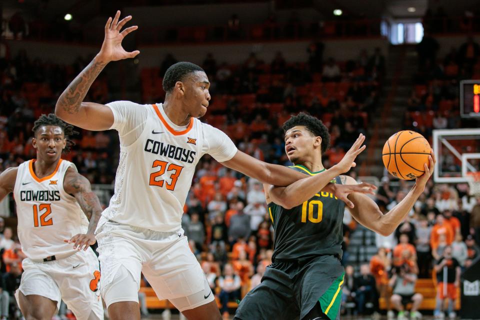 Baylor guard RayJ Dennis (10) tries to get around Oklahoma State center Brandon Garrison (23) during overtime at Gallagher-Iba Arena on Jan. 6.  Garrison is the highest-rated transfer to commit to play for Kentucky next season, according to 247Sports.