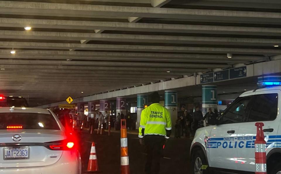 Airport staff members with “Traffic Control” vests are stationed in the combined pick-up and drop-off zone to keep vehicles from idling too long.