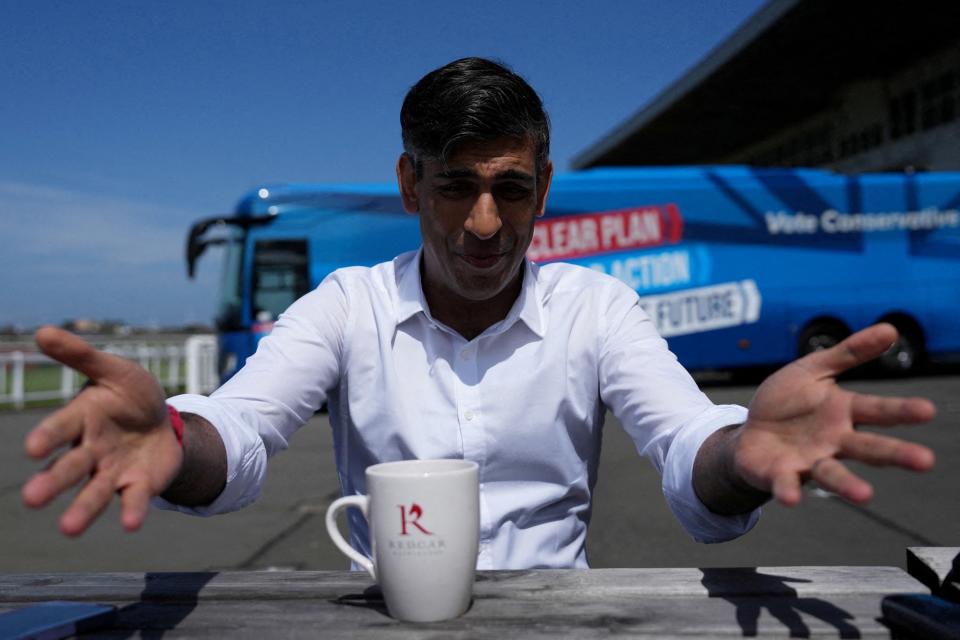 British Prime Minister Rishi Sunak gestures as he speaks to journalists at Redcar racecourse as he launches the Conservative campaign bus (via REUTERS)