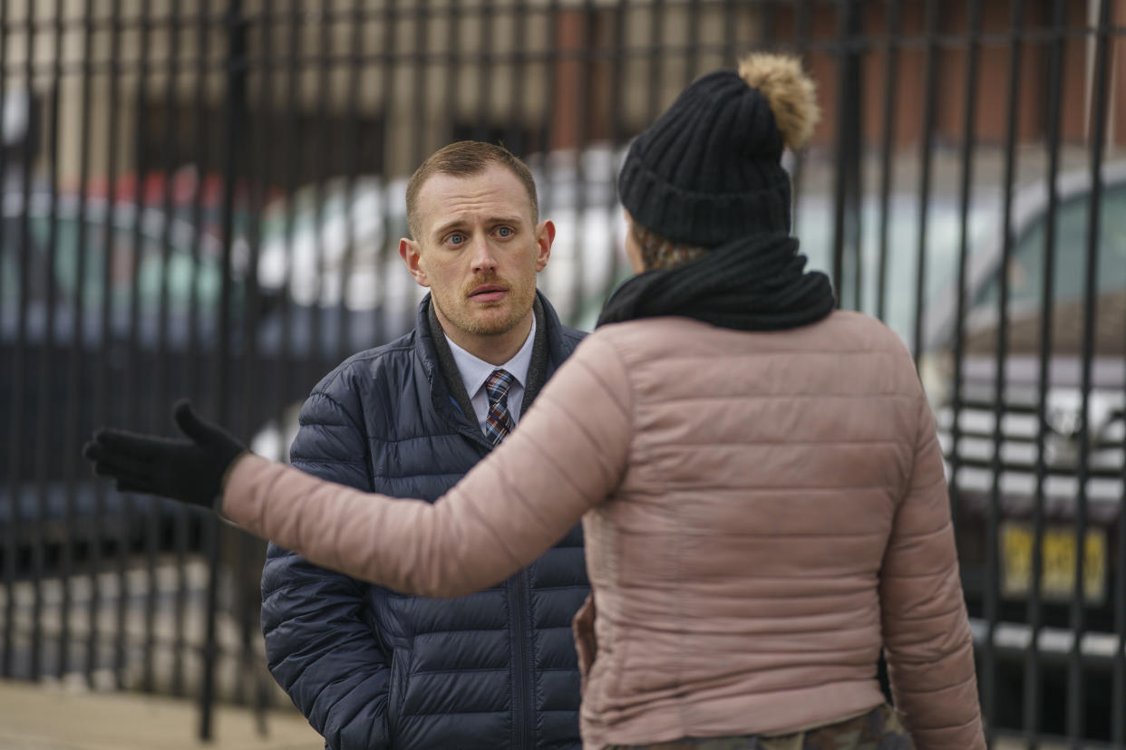 Josh Kruger speaks to someone at a tent encampment in Philadelphia in 2020. 