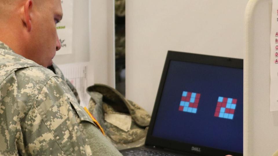 A soldier from the 501st Area Support Medical Company is shown patterned squares during the Automated Neuropsychological Assessment Metric. (Army)