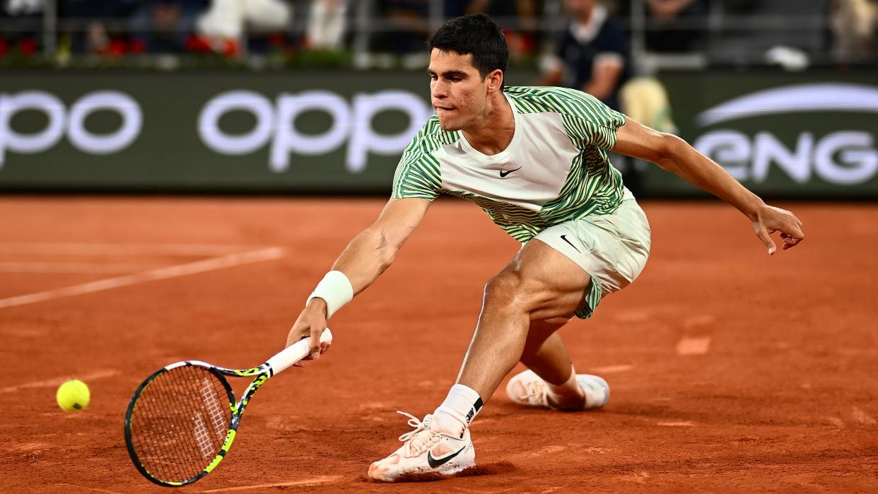  Carlos Alcaraz of Spain stretches for the ball at the 2023 French Open at Roland Garros 