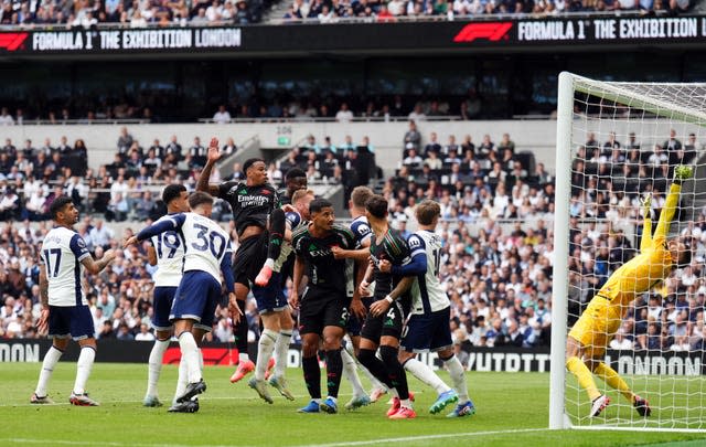 Gabriel rises above a host of players to head home the only goal of the north London derby