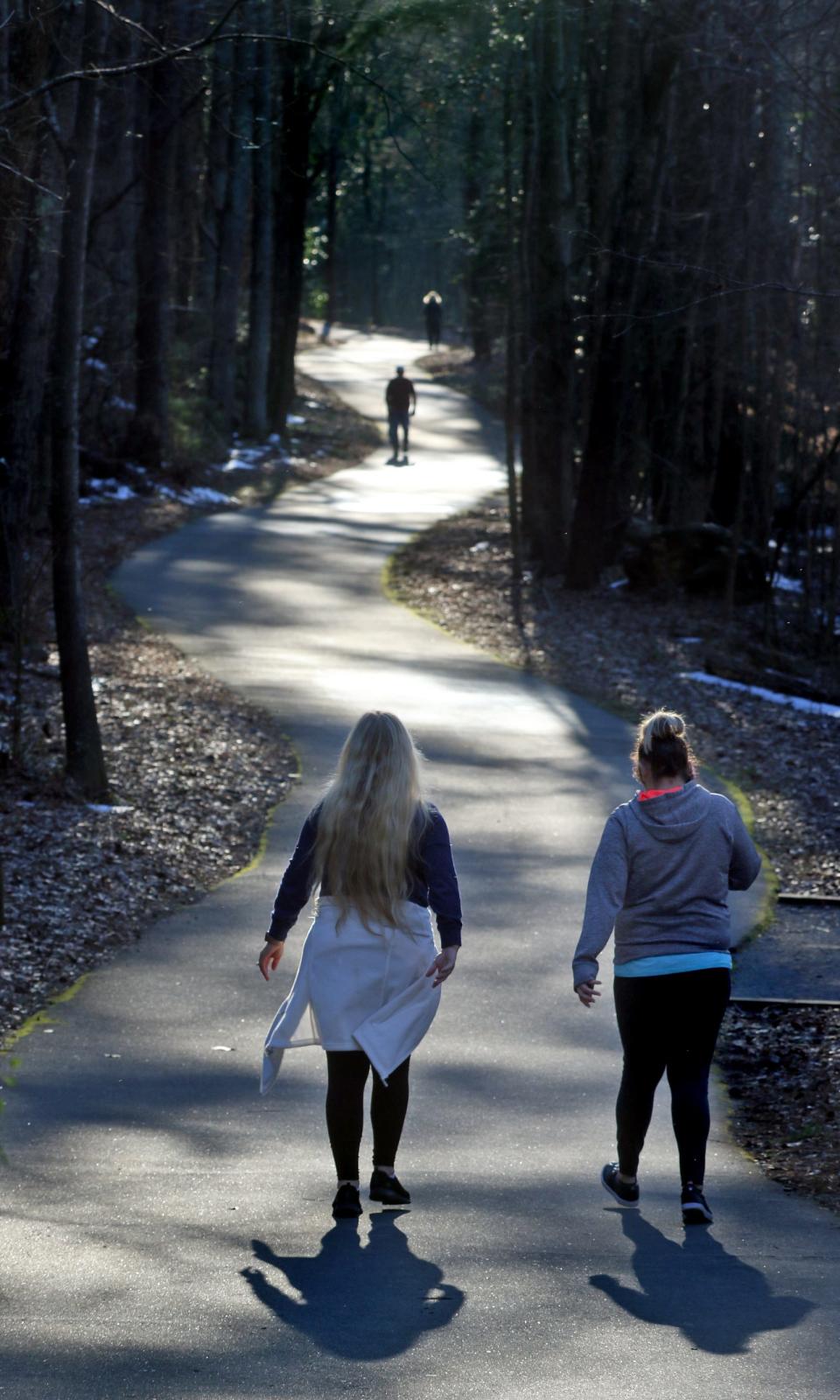 People walk along the Rail Trail Loop Tuesday afternoon, Jan. 25, 2022, at the Gateway Trail in Kings Mountain.