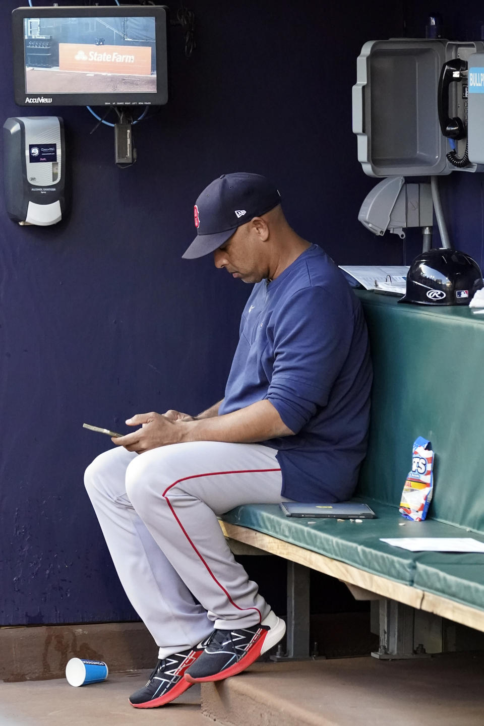 Boston Red Sox manager Alex Cora (13) sits in the dugout during a baseball game against the Atlanta Braves Wednesday, May 11, 2022, in Atlanta. (AP Photo/John Bazemore)