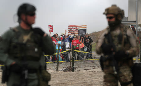 People take part in a gathering in support of the migrant caravan in San Diego, U.S., close to the border wall between the United States and Mexico, as seen from Tijuana, Mexico December 10, 2018. REUTERS/Mohammed Salem